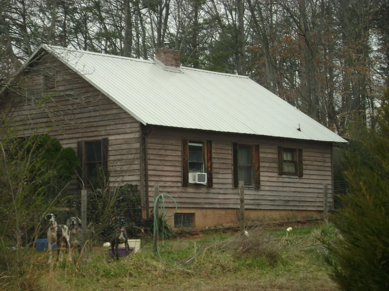 White metal roof on an old wood sided farmhouse, from a Metal Roof Installation job in Corinne